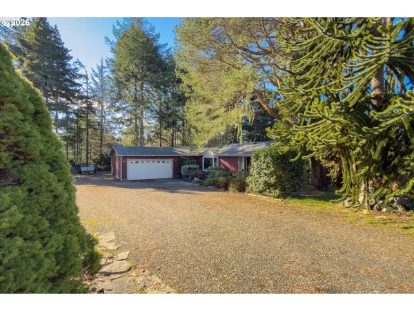 a view of a house with a yard and garage