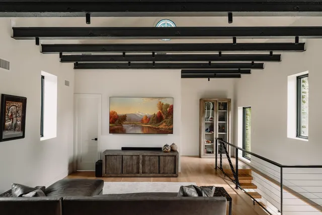 a living room with furniture and a potted plant