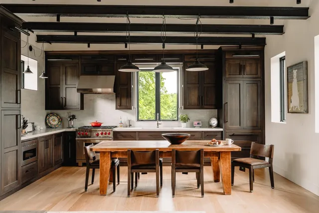 a kitchen with a table chairs and a sink