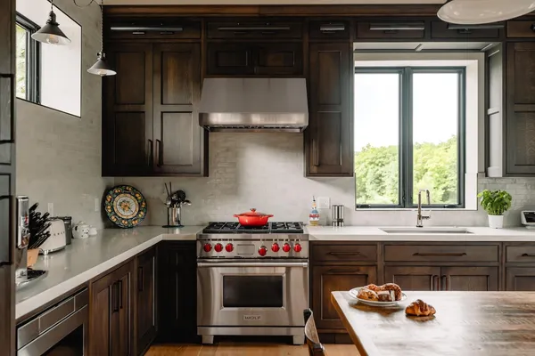 a kitchen with stainless steel appliances a stove a sink and a microwave