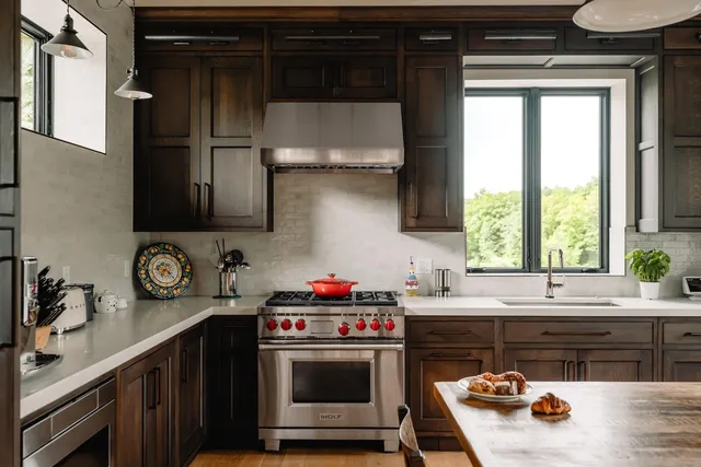 a kitchen with stainless steel appliances a stove a sink and a microwave