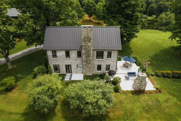 an aerial view of a house with garden space and street view