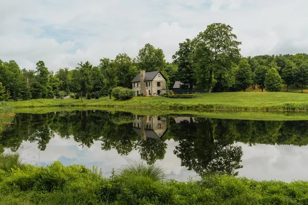 a view of a lake with a house in the background