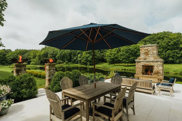 a view of a patio with furniture and a yard