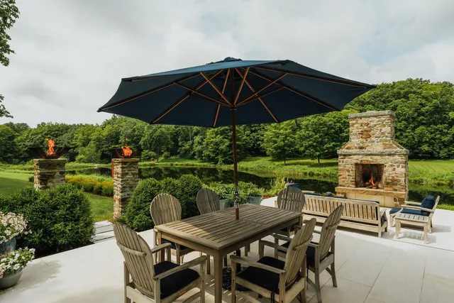 a view of a patio with furniture and a yard