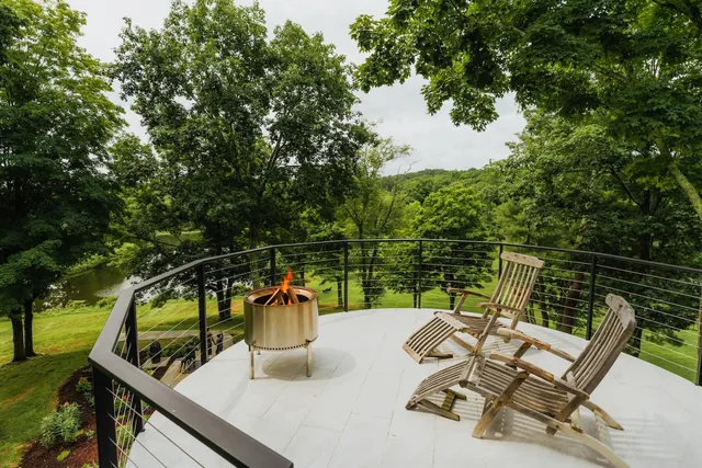 a view of a chairs and table in the balcony