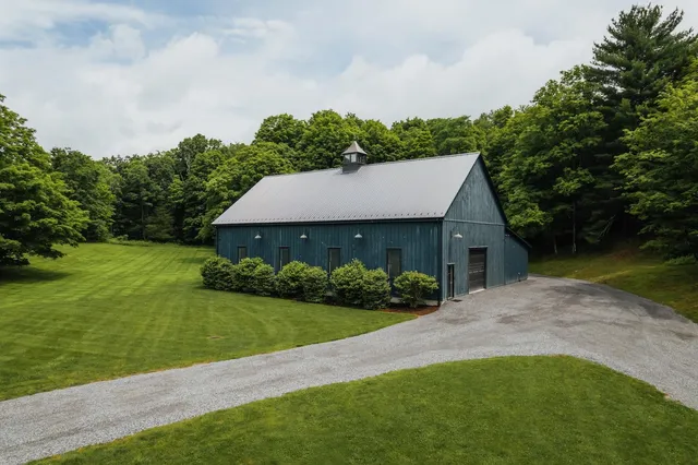 a view of a house with a yard and potted plants