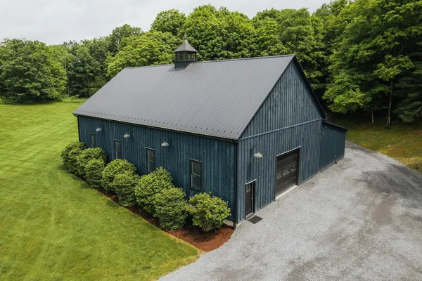 a aerial view of a house with a yard and potted plants