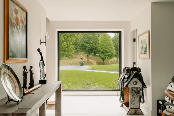 a view of a livingroom with furniture and floor to ceiling window