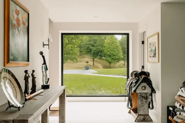 a view of a livingroom with furniture and floor to ceiling window
