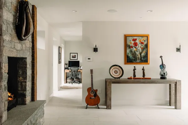 a view of living room with furniture and a fireplace