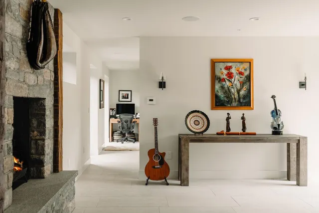 a view of living room with furniture and a fireplace