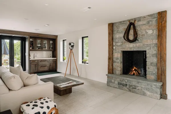 a living room with furniture a flat screen tv and a fireplace