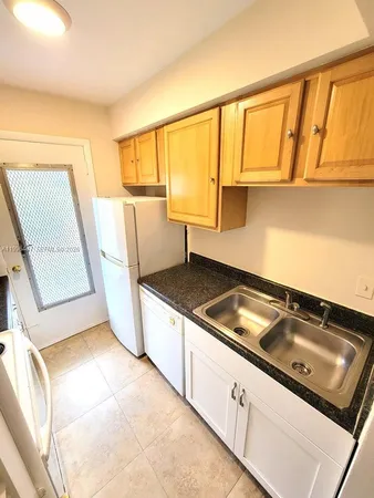a stove top oven sitting inside of a kitchen