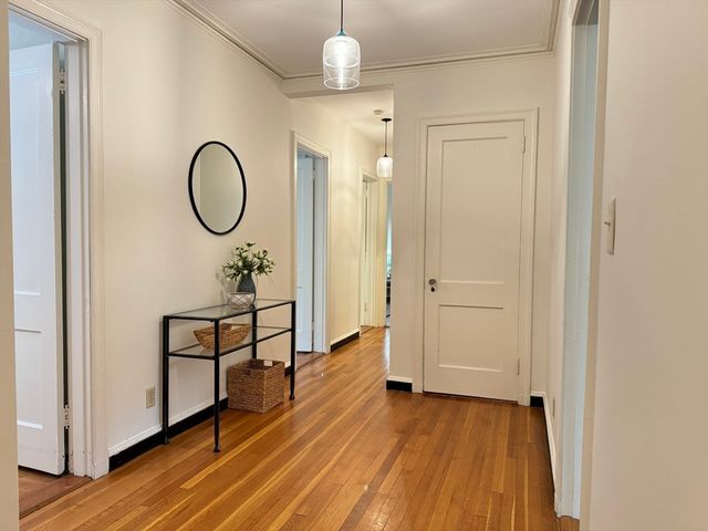 a view of a room with wooden floor and window