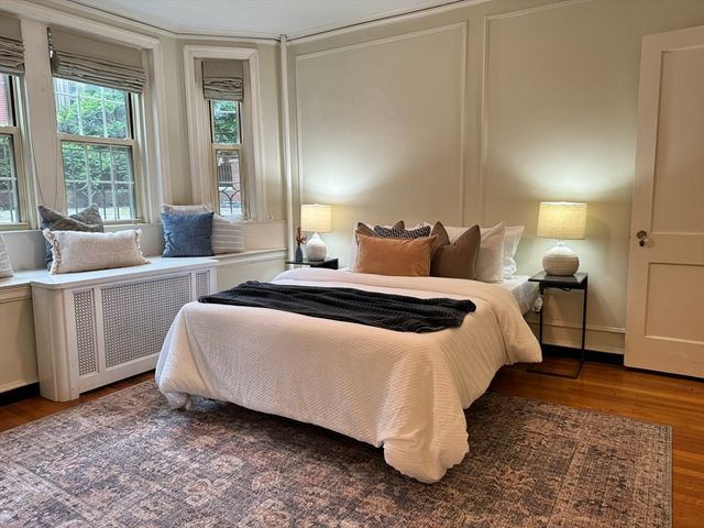 a bedroom with a bed and wooden floor