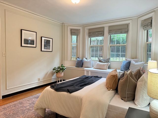 a bedroom with two beds and a large window