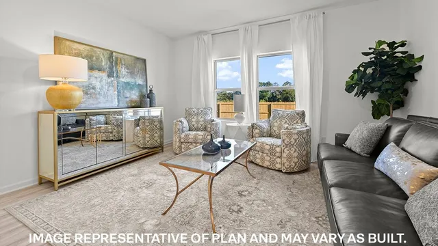 a living room with furniture and a potted plant