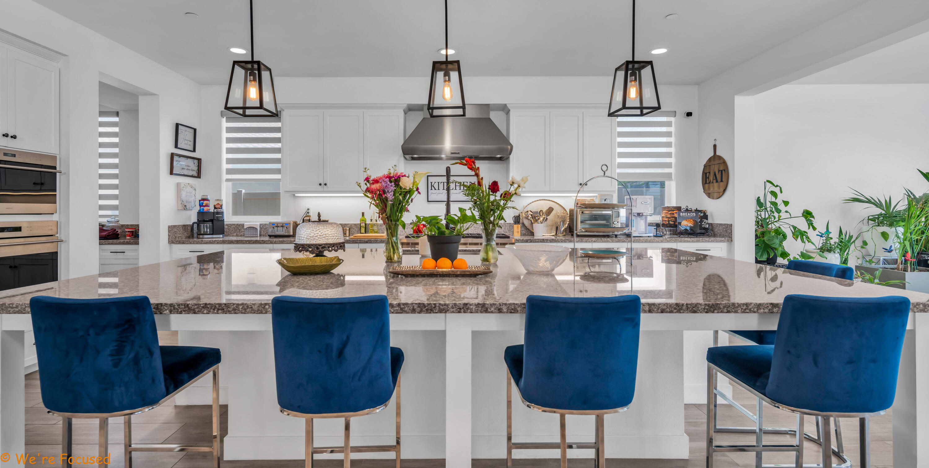 17126 Blue Lake Court Riverside, CA 92503 - Photo 21 of 75 a kitchen with stainless steel appliances kitchen island granite countertop a table and chairs in it