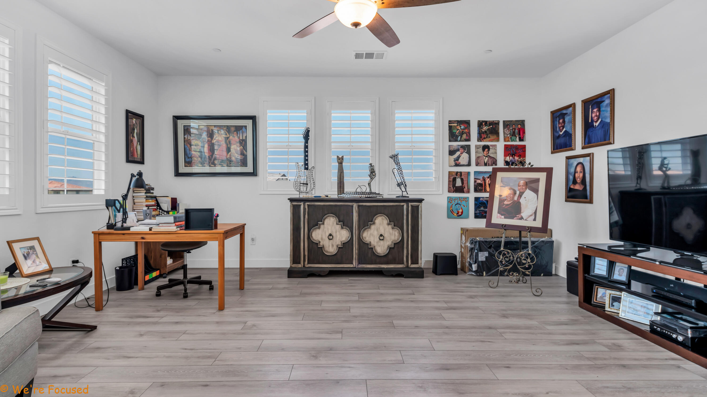 17126 Blue Lake Court Riverside, CA 92503 - Photo 50 of 75 a living room with furniture a bookshelf and a flat screen tv