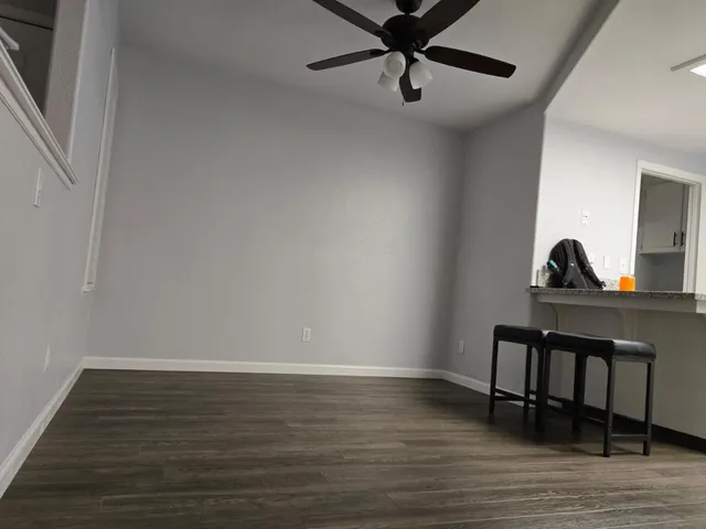a view of a room with wooden floor and furniture
