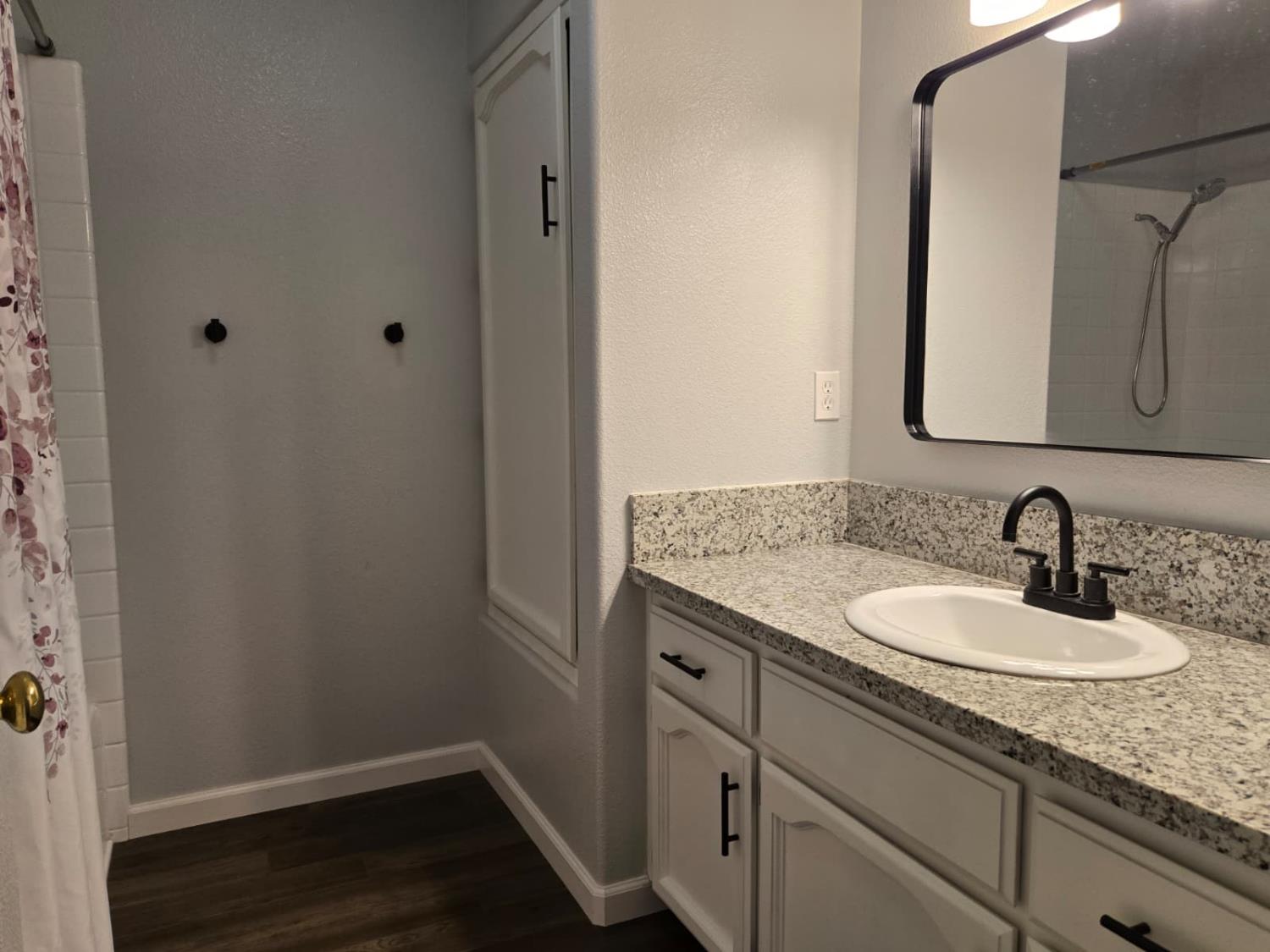 2645 Fowler Avenue Clovis, CA 93611 - Photo 7 of 11 a bathroom with a granite countertop sink and a mirror
