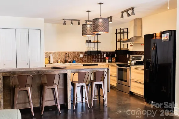 a kitchen with stainless steel appliances kitchen island wooden cabinets and stove