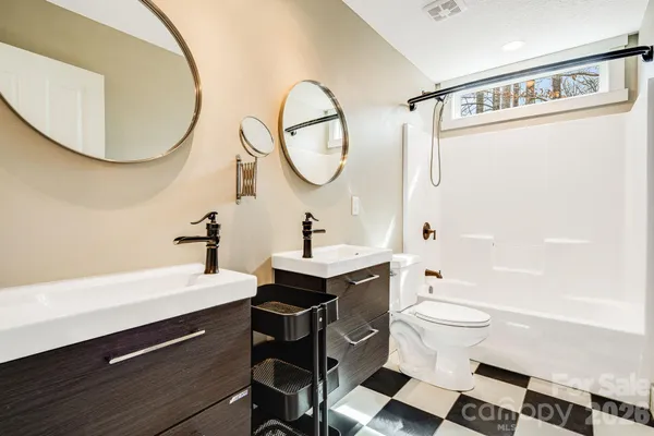 a view of a room with wooden floor and a window