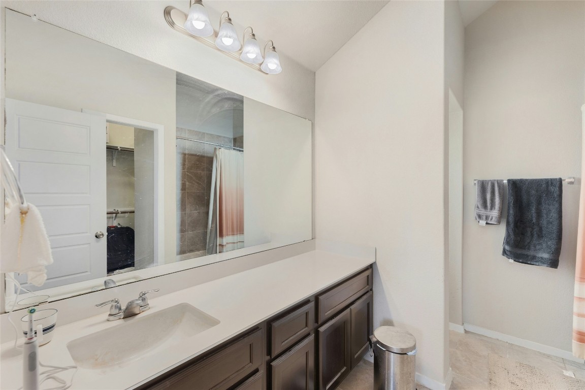 7920 Castelardo Place, Unit 50 Round Rock, TX 78665 - Photo 17 of 28 a bathroom with a sink double vanity and a mirror