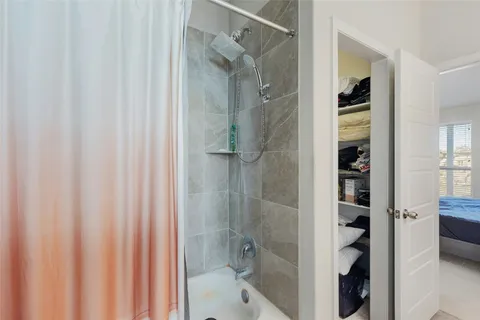 a bathroom with a shower and a sink