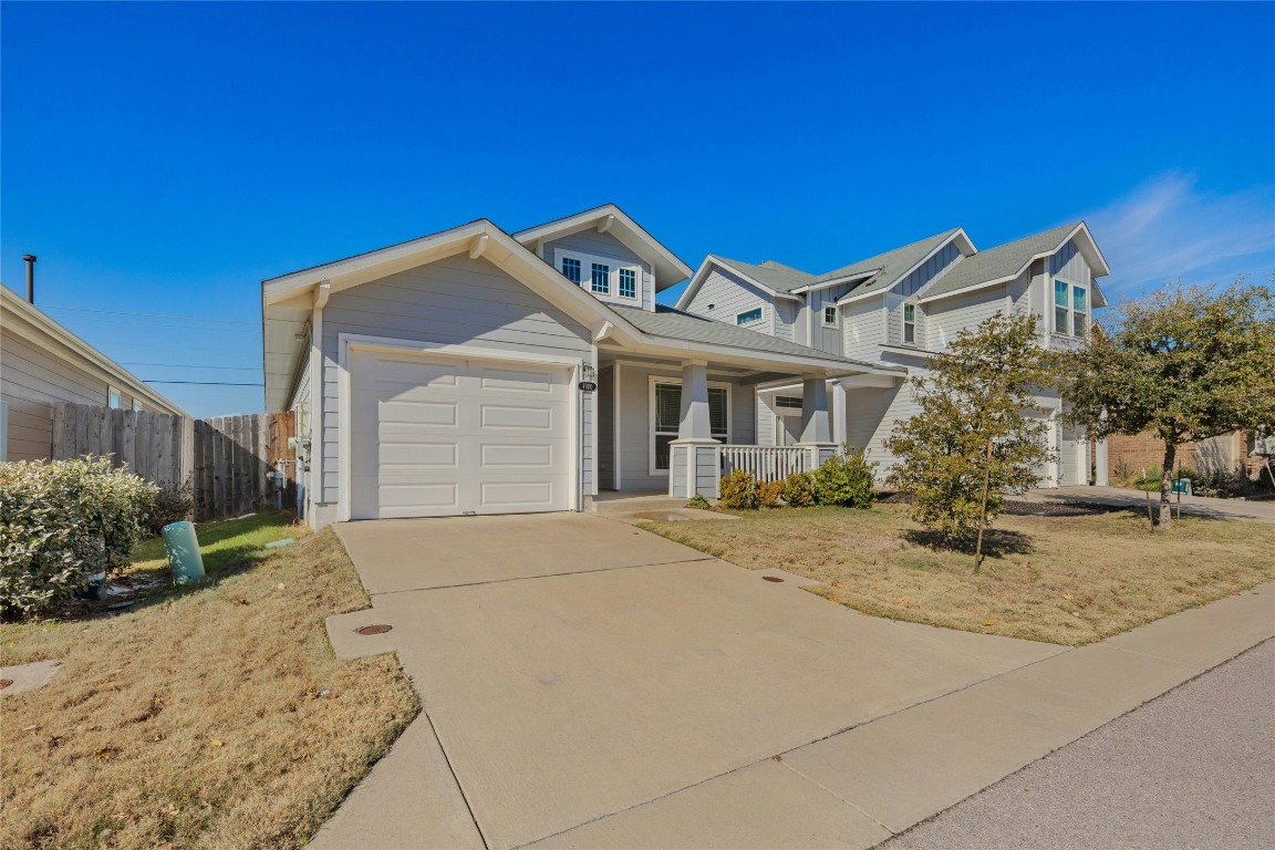 7920 Castelardo Place, Unit 50 Round Rock, TX 78665 - Photo 2 of 28 a front view of a house with yard and garage