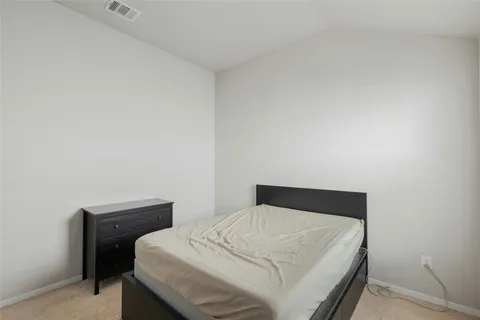 a bedroom with a bed and a table