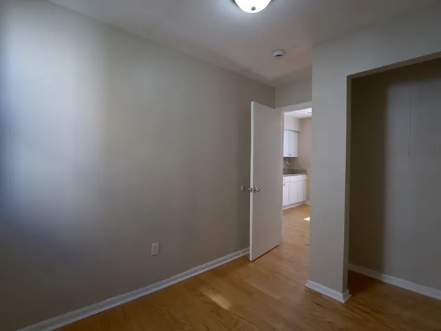 a view of a room with wooden floor