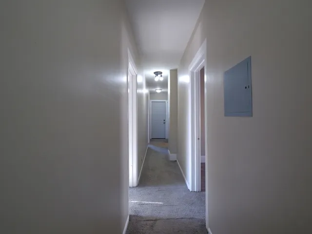 a view of a hallway with an entryway