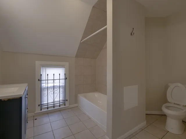 a bathroom with a bathtub and toilet