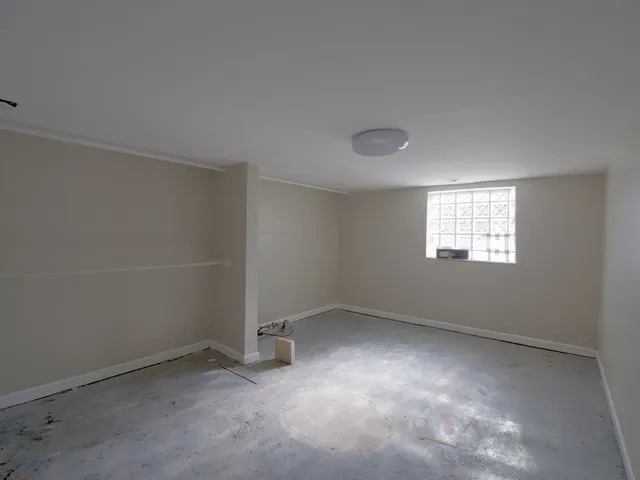an empty room with a empty space and windows