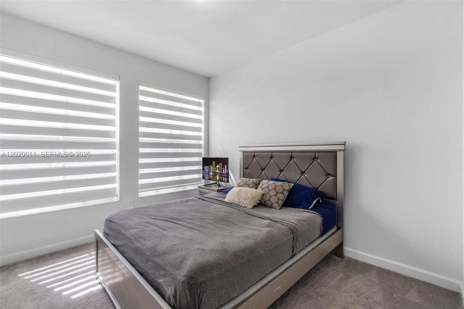 26455 Southwest 148th Avenue Homestead, FL 33032 - Photo 13 of 35 a bedroom with a bed and window