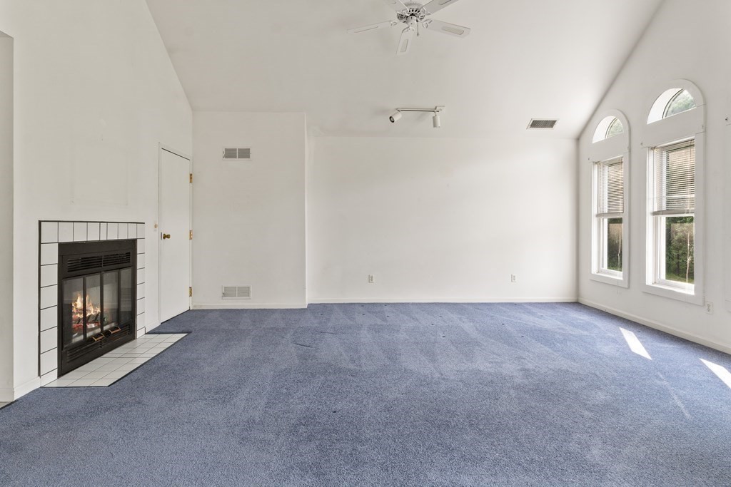 29 Ledgebrook Drive, Unit 29 Blackstone, MA 01504 - Photo 12 of 38 a view of an empty room with a fireplace and a window