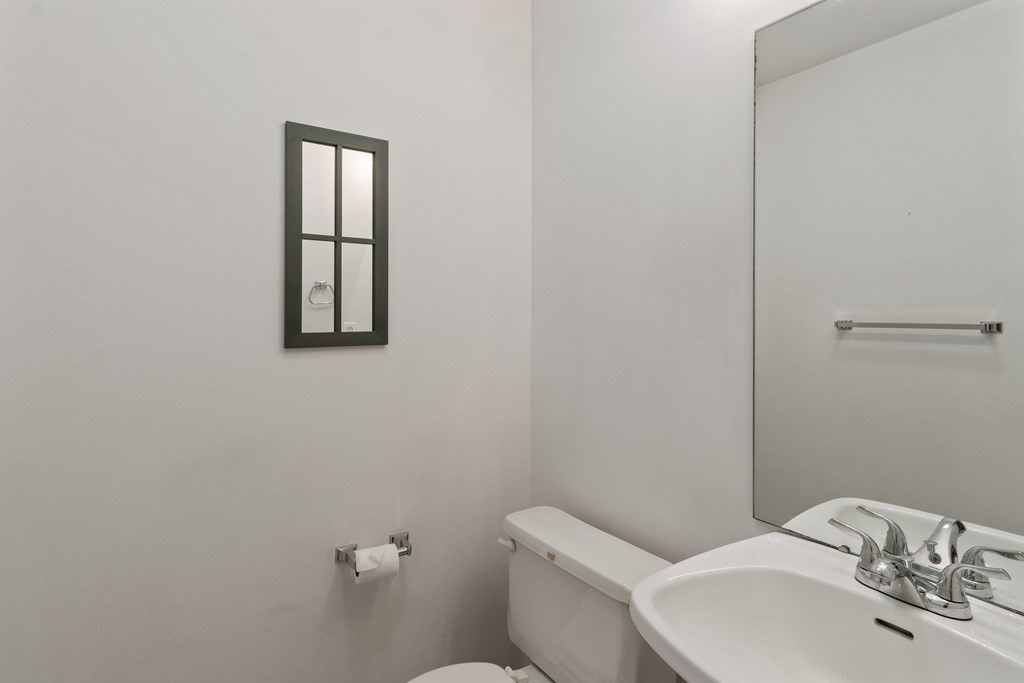 29 Ledgebrook Drive, Unit 29 Blackstone, MA 01504 - Photo 29 of 38 a bathroom with a toilet a sink and mirror