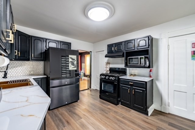 87 Oak Street Springfield, MA 01151 - Photo 4 of 17 a kitchen with stainless steel appliances granite countertop a stove and a refrigerator