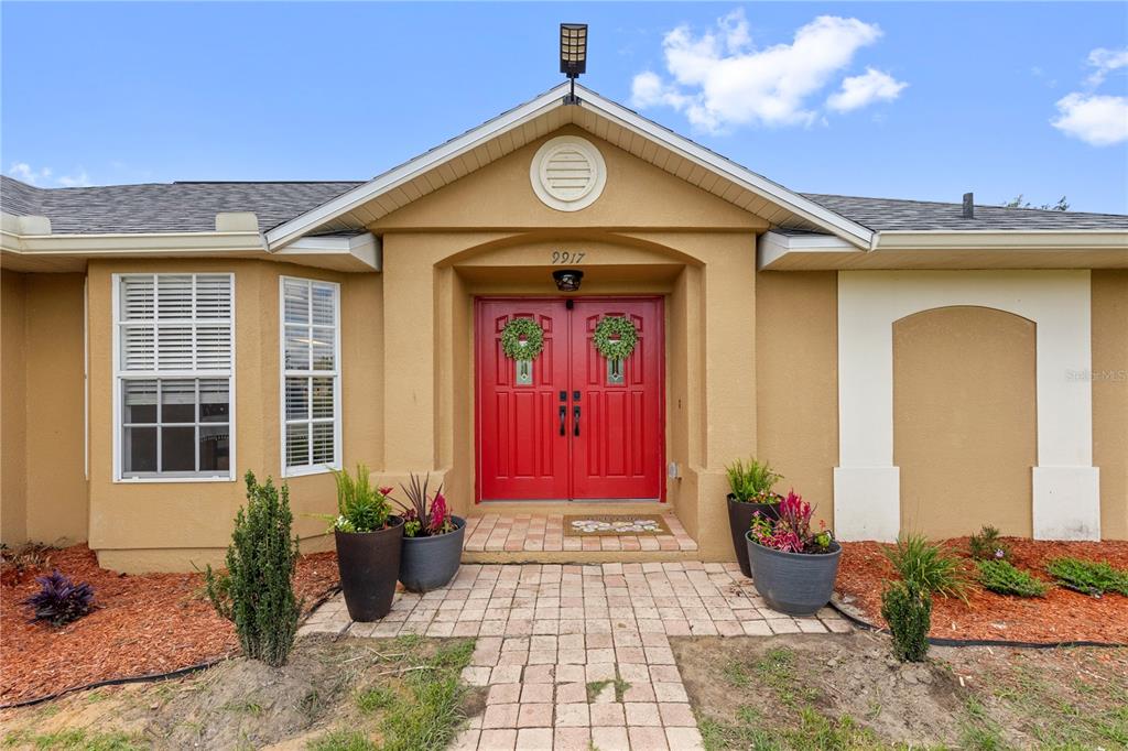 9917 Nelson Road Dade City, FL 33525 - Photo 8 of 40 a front view of a house with garden