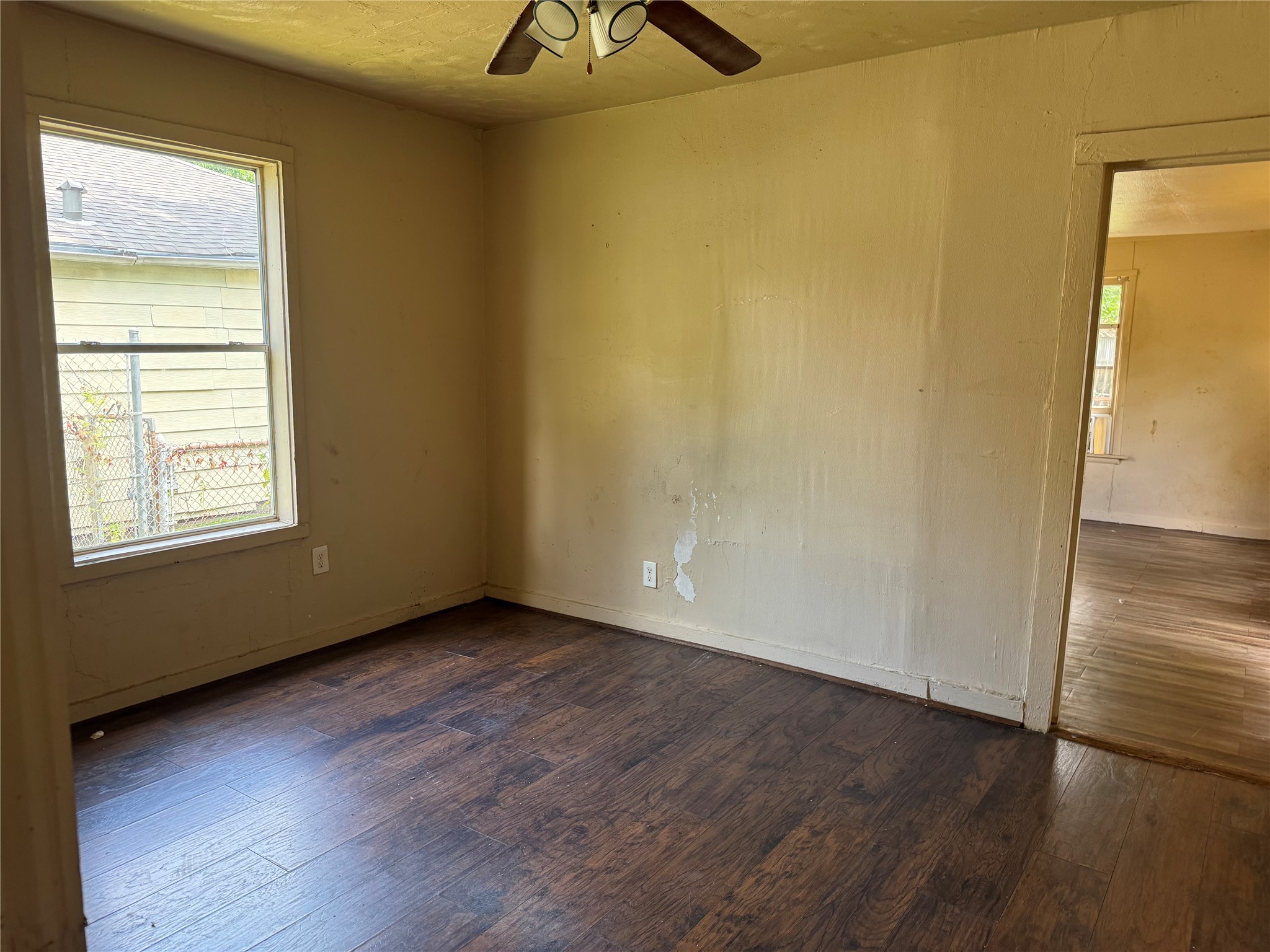606 East 42nd Street Houston, TX 77022 - Photo 10 of 14 an empty room with wooden floor and windows