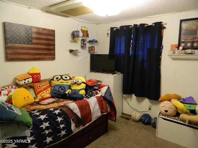 a bedroom with a bed and a dresser in it