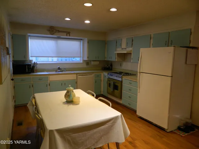 a kitchen with a sink a refrigerator and a stove