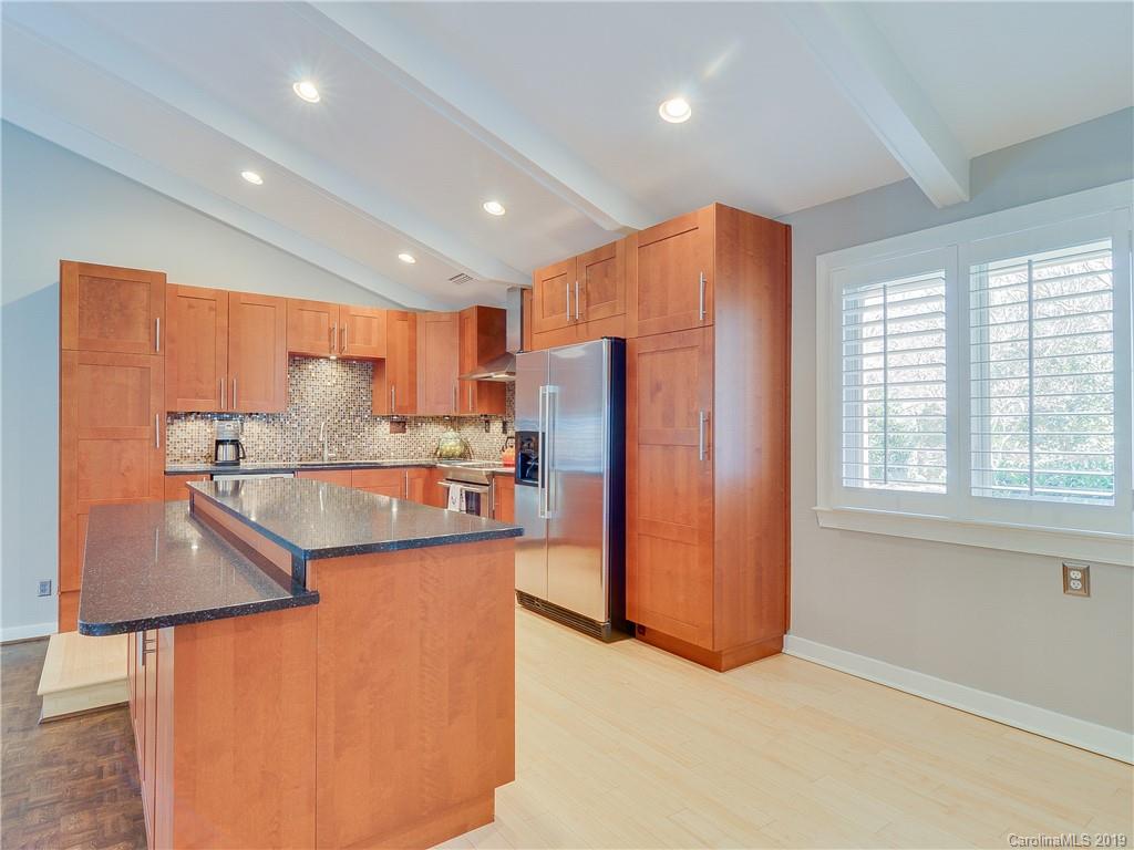 3108 Colony Road Charlotte, NC 28211 - Photo 22 of 36 a kitchen with stainless steel appliances granite countertop a refrigerator a sink a stove and a refrigerator with wooden floor