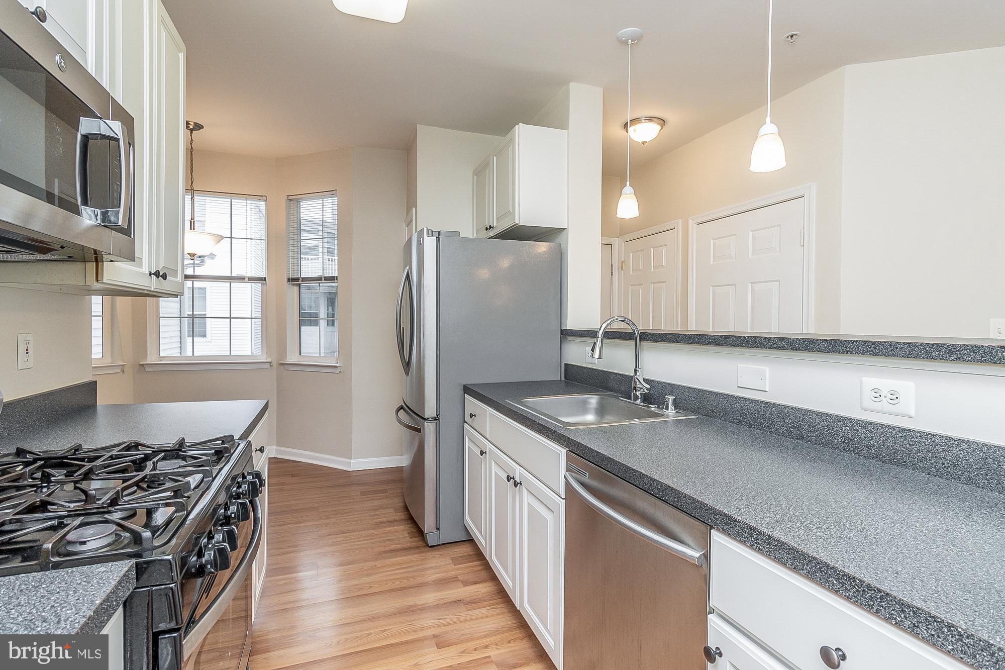 18 Hawk Rise Lane, Unit 205 Owings Mills, MD 21117 - Photo 13 of 29 a kitchen with stainless steel appliances granite countertop a sink stove and refrigerator
