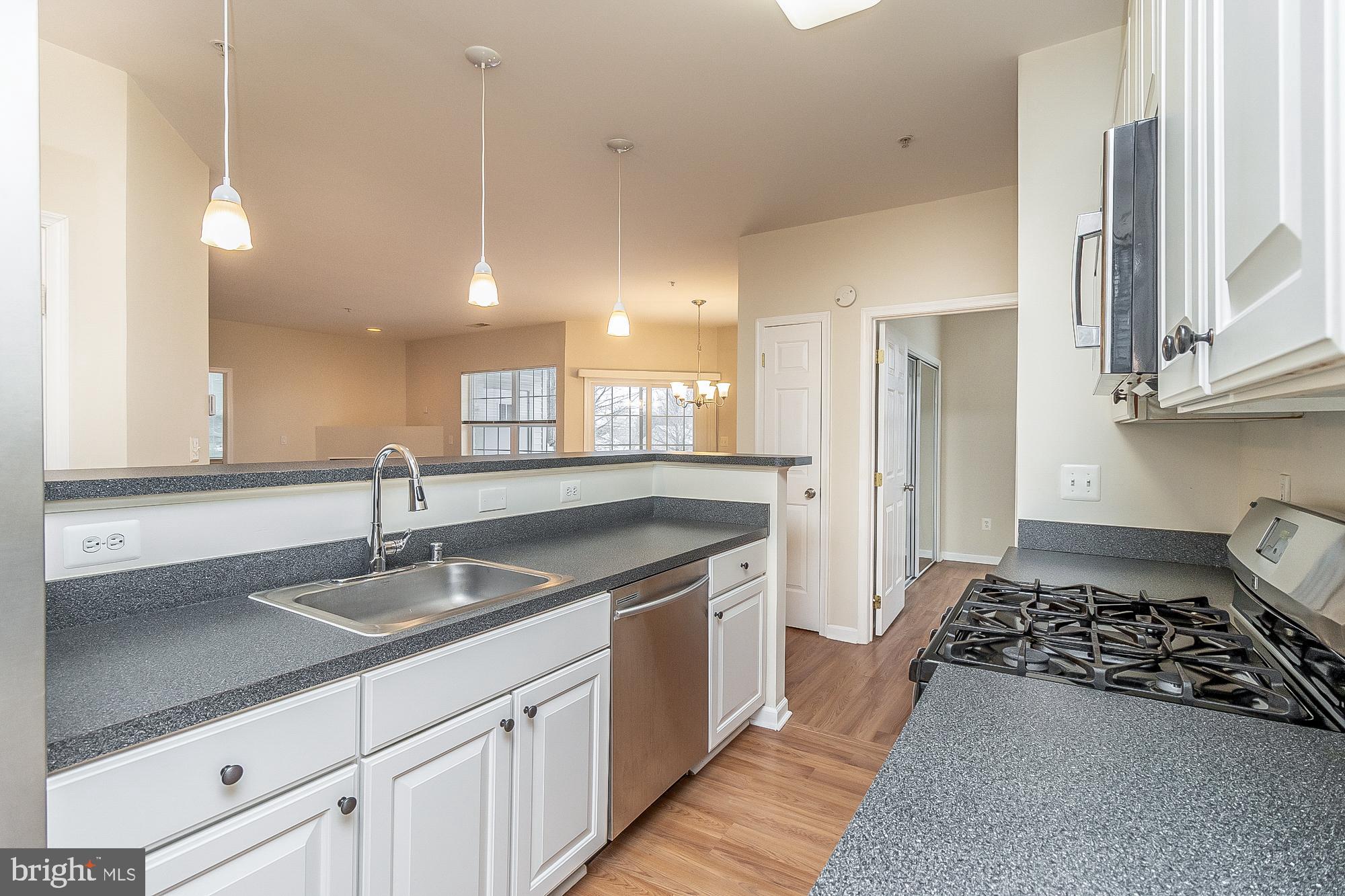 18 Hawk Rise Lane, Unit 205 Owings Mills, MD 21117 - Photo 14 of 29 a kitchen with a sink a counter space and stainless steel appliances
