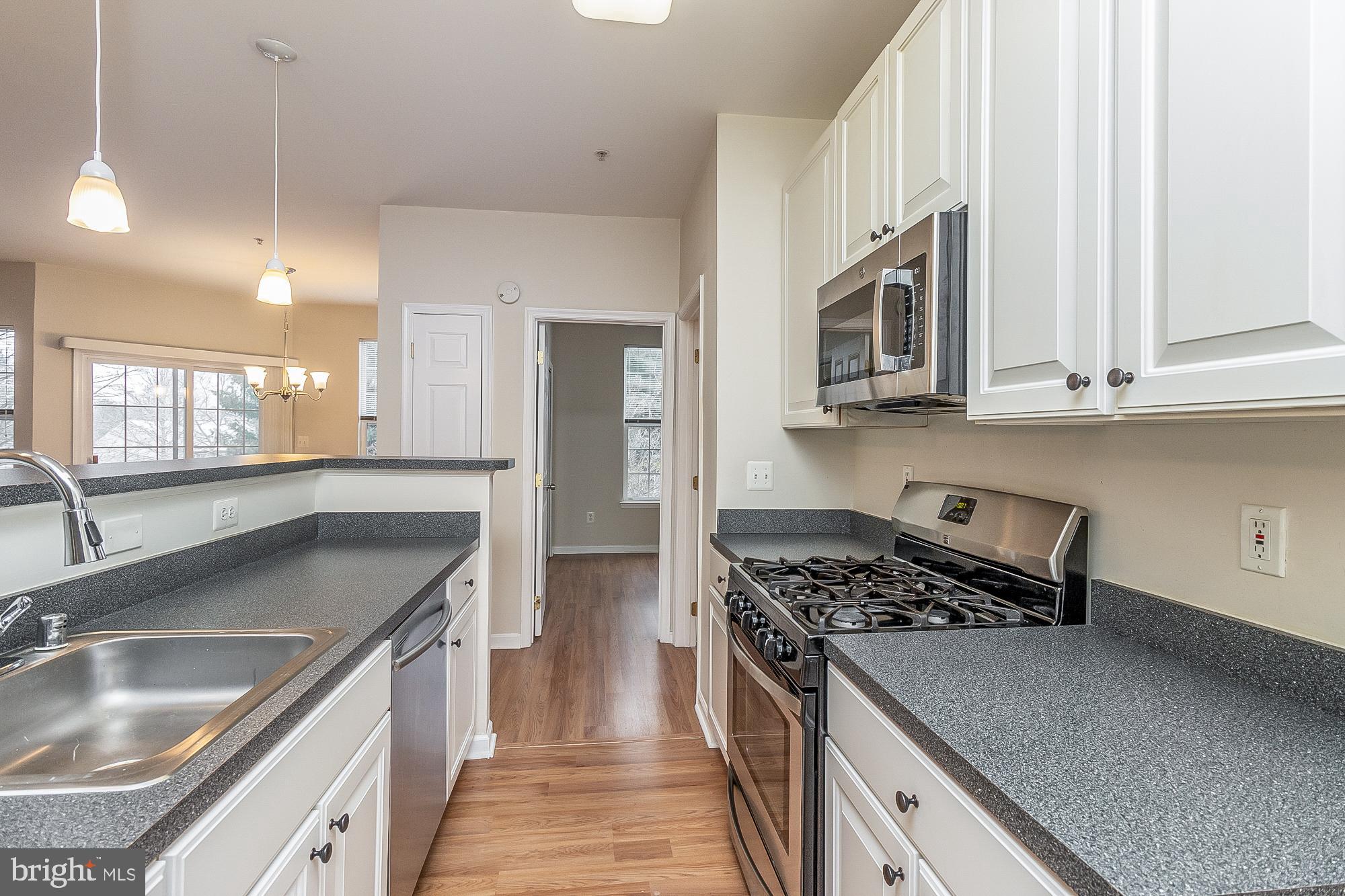 18 Hawk Rise Lane, Unit 205 Owings Mills, MD 21117 - Photo 15 of 29 a kitchen with stainless steel appliances granite countertop a sink stove and refrigerator