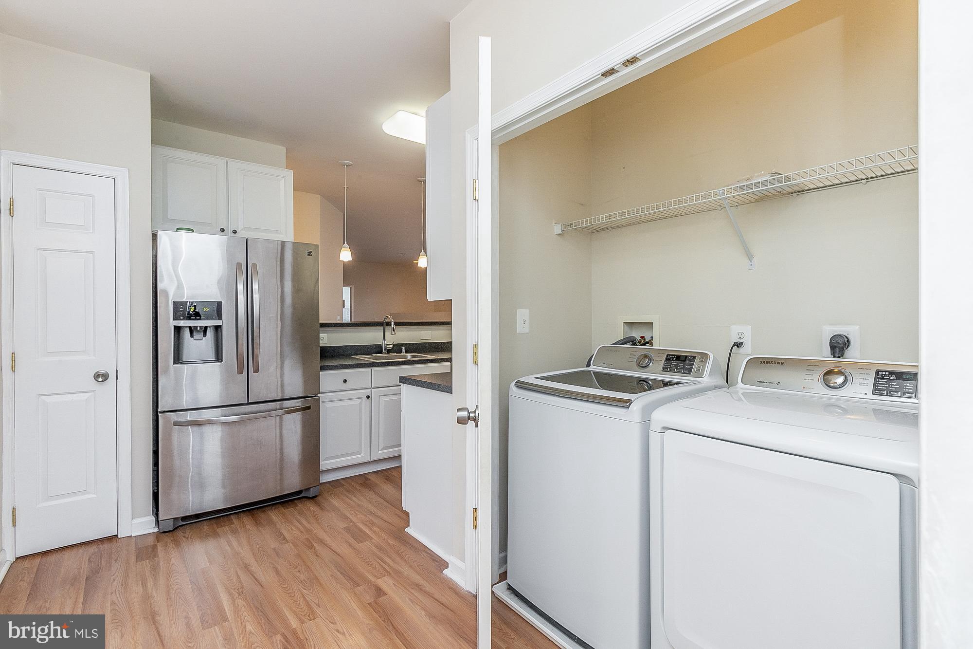 18 Hawk Rise Lane, Unit 205 Owings Mills, MD 21117 - Photo 16 of 29 a kitchen with a refrigerator sink and wooden floor