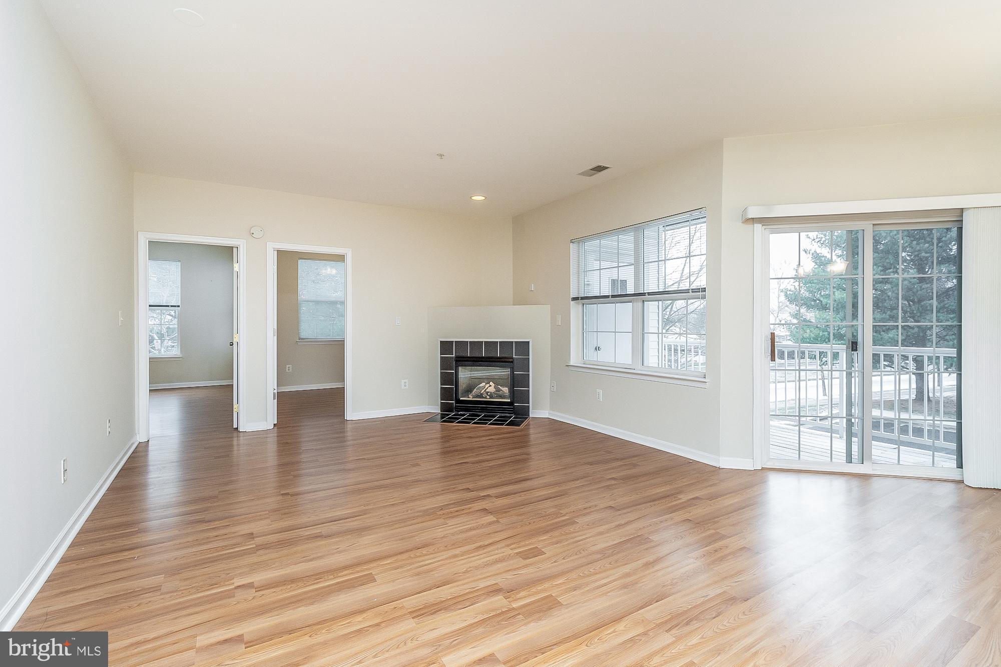 18 Hawk Rise Lane, Unit 205 Owings Mills, MD 21117 - Photo 18 of 29 a view of an empty room with wooden floor and a window